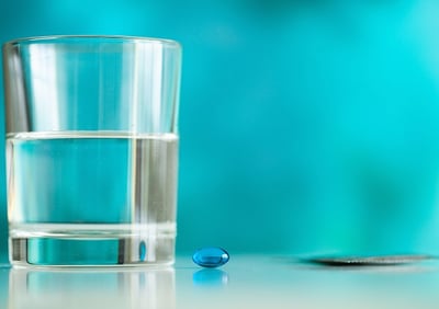 Ein Glas Wasser und eine Tablette