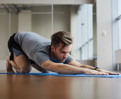 Ein Mann macht Yoga, um seine Beckenbodenmuskeln zu trainieren.